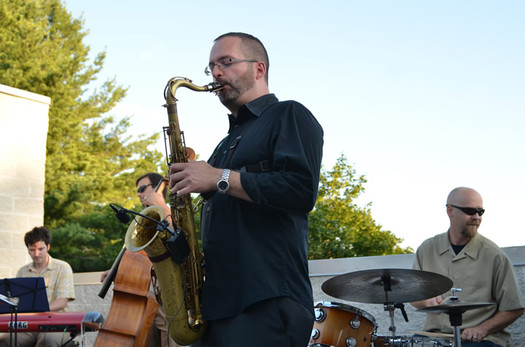 Thumbnail image for brian patneaude quartet playing on roof