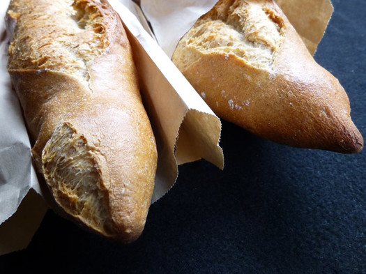 placid baker baguettes peeking out from bags