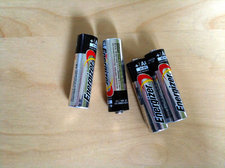 four AA alkaline batteries on desk