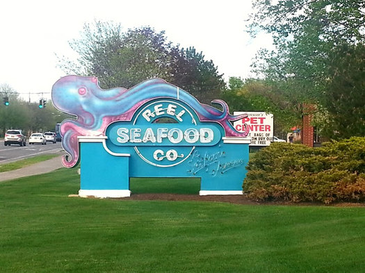 Reel Seafood Co Wolf Road sign