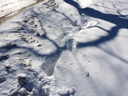 snow covered sidewalk footprints