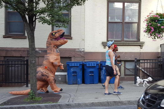 dinosaur walking down Lark Street