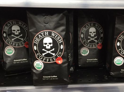 bags of death wish coffee on supermarket shelf