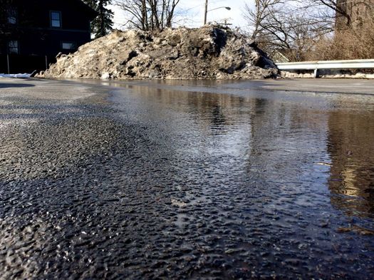 melting pile of dirty parking lot snow