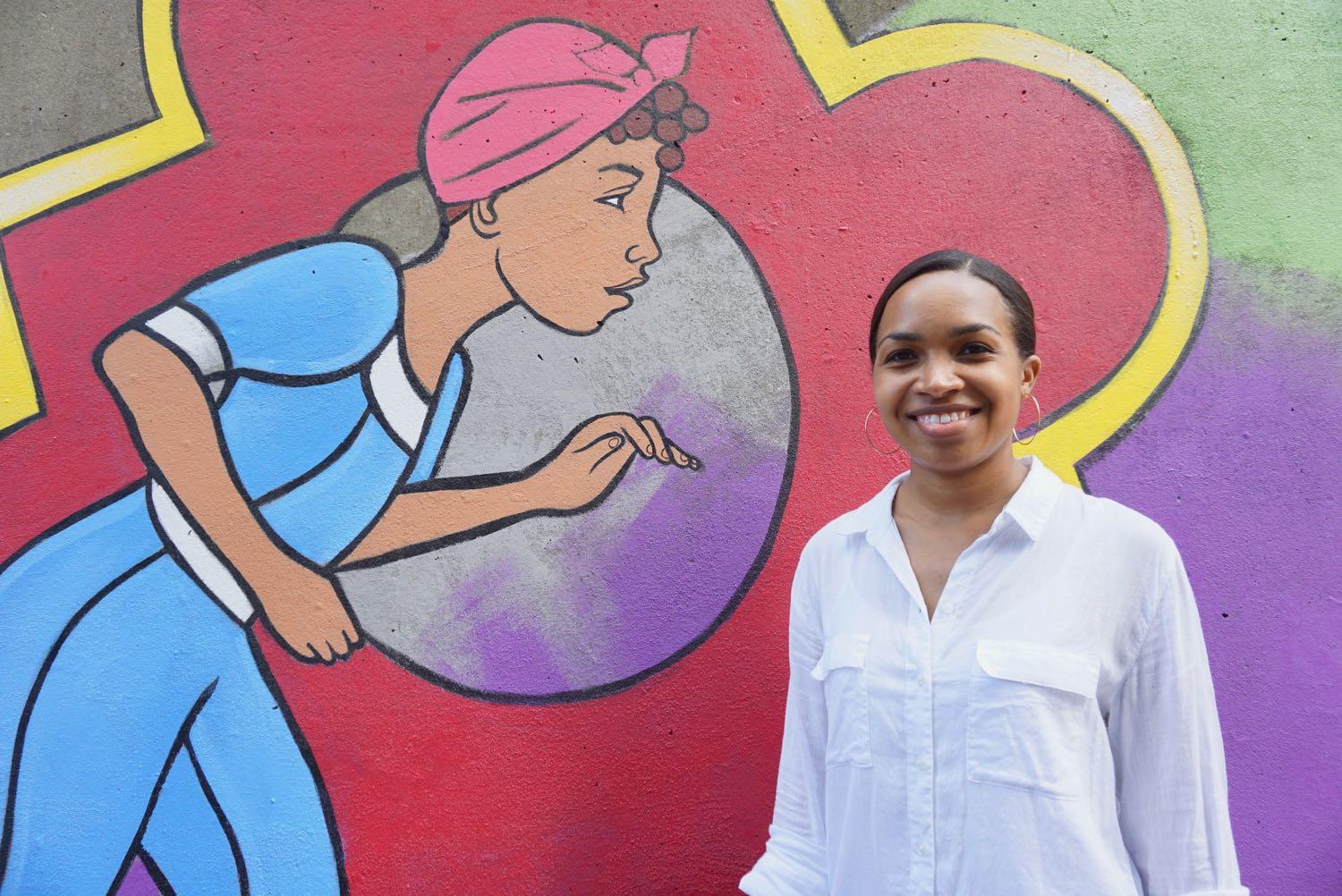 Liz Zunon and her mural in downtown Albany