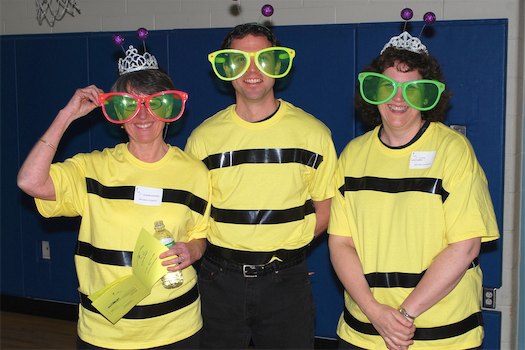 adults dressed in funny glasses and bee shirts