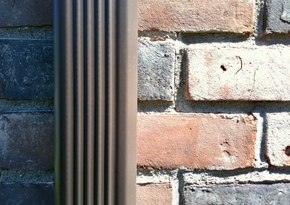 brick wall gutter down spout