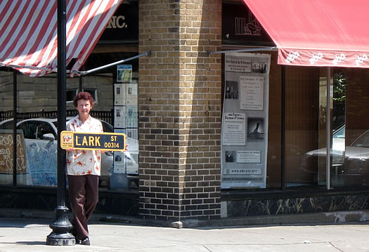 maude baum holding lark street sign