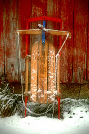 old sled against barn