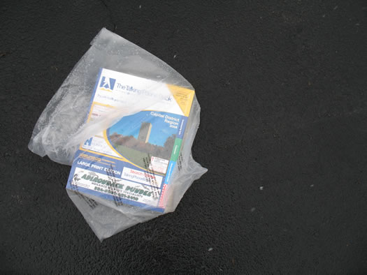 a phone book sitting in a driveway